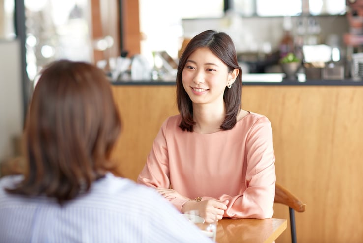 Candid Conversation Between Two Women at a Café