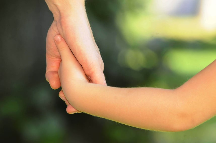 Child and Parent Holding Hands